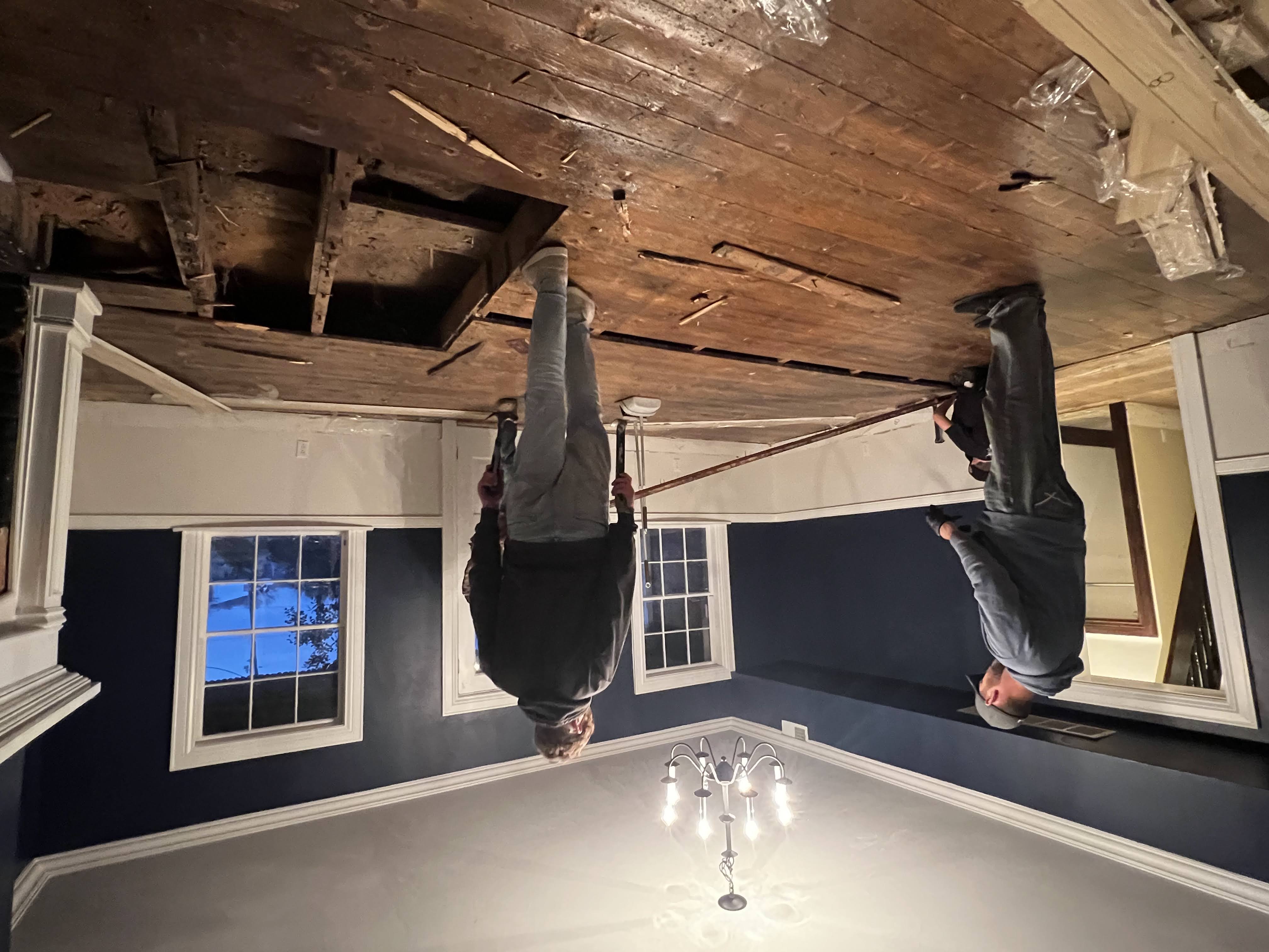 Crew stacking reclaimed boards during removal